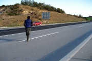 We sprint across the motorway barrier