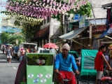 A colorful street and a tricycle rider in Manila