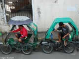 Tricycle riders wait for their customers