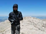 At the summit. Having hard time to stand due to the gusty wind.